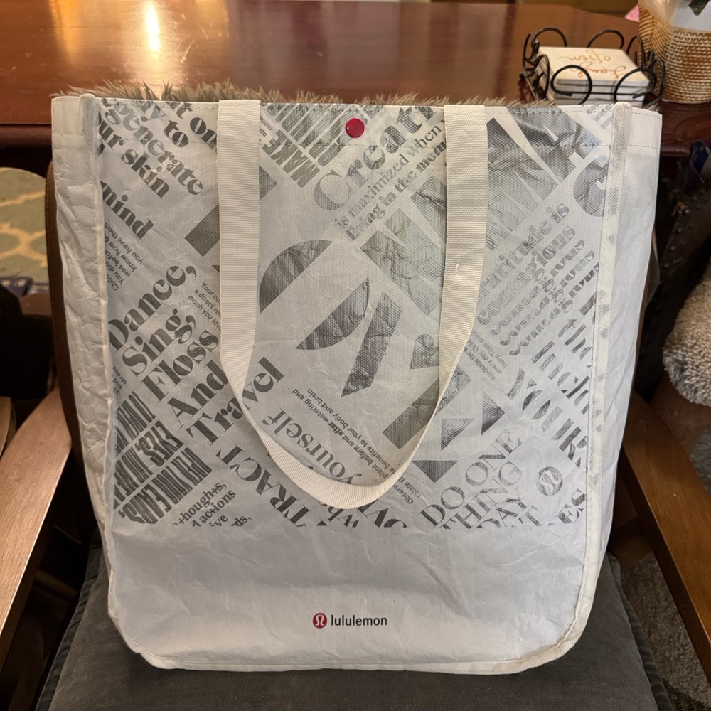 Large reusable Lululemon bag/tote w/snap closure. Shoulder strap on each side.